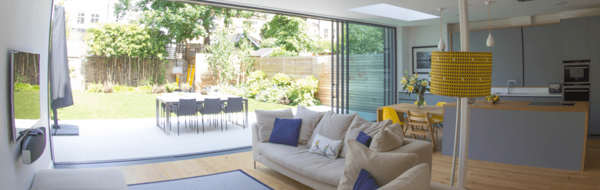 Living room with two sofas and large window near kitchen