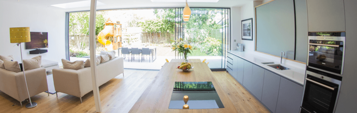 Complete kitchen refurbishment with white walls, large window wooden furniture and floor