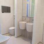 Bathroom with double white sink mirror and toilet