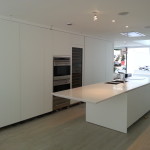 Large kitchen with white furniture, cooker and worktop