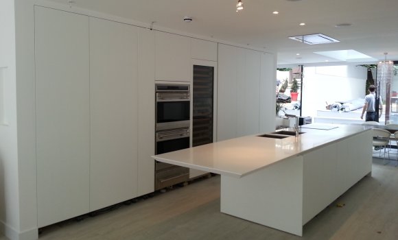 Large kitchen with white furniture, cooker and worktop