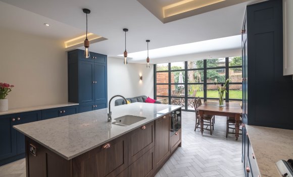 Refurbishment kitchen with dark blue, brown furnitures and marble countertop