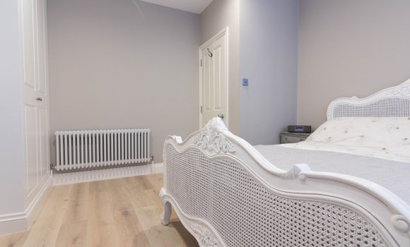 Completely refurbished bedroom with double bed and radiator